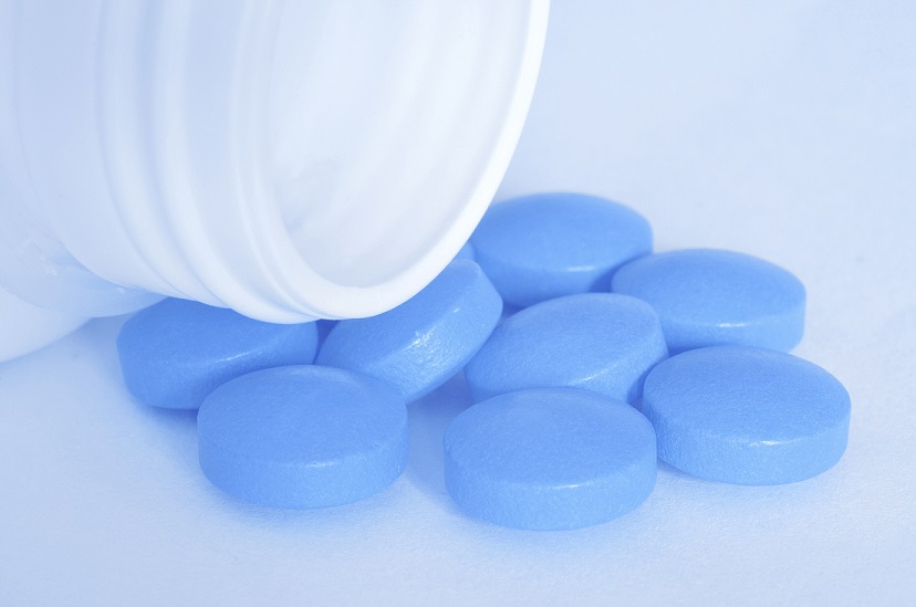 medicine bottle with blue pills for viagra