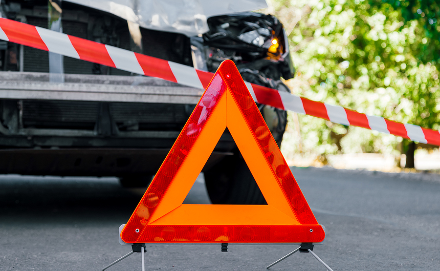 Red Emergency Stop Triangle Sign And Red White Police Tape On Ro