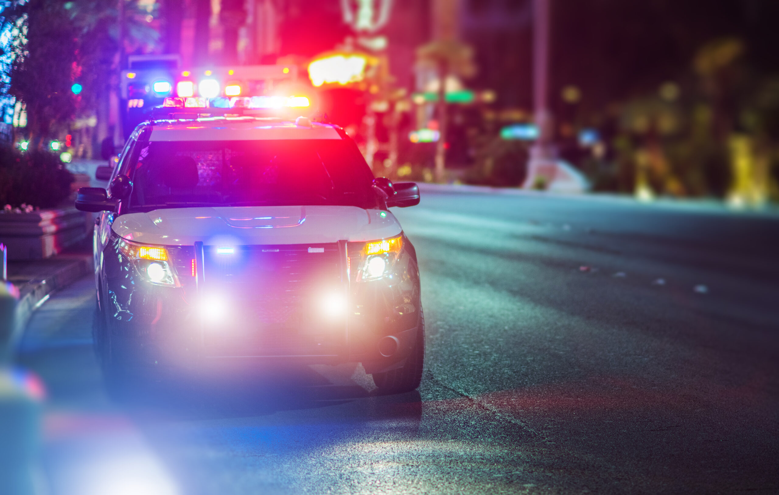 Sport Utility Vehicle Police Cruiser Emergency Assistance on the City Street. Police Car with Flashing Lights.