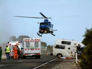 a helicopter lifts off at the scene of a car accident on the highway