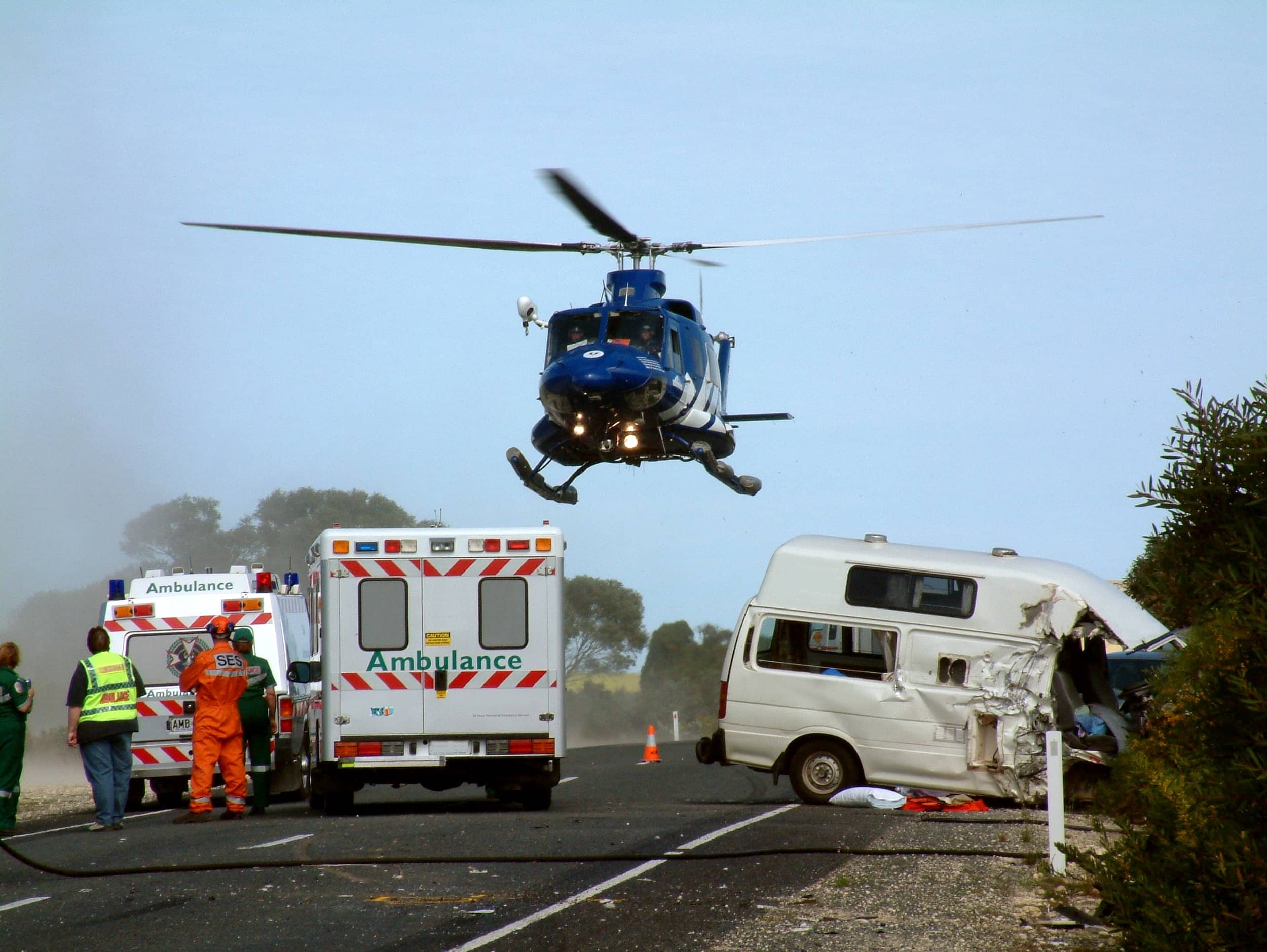 a helicopter lifts off at the scene of a car accident on the highway