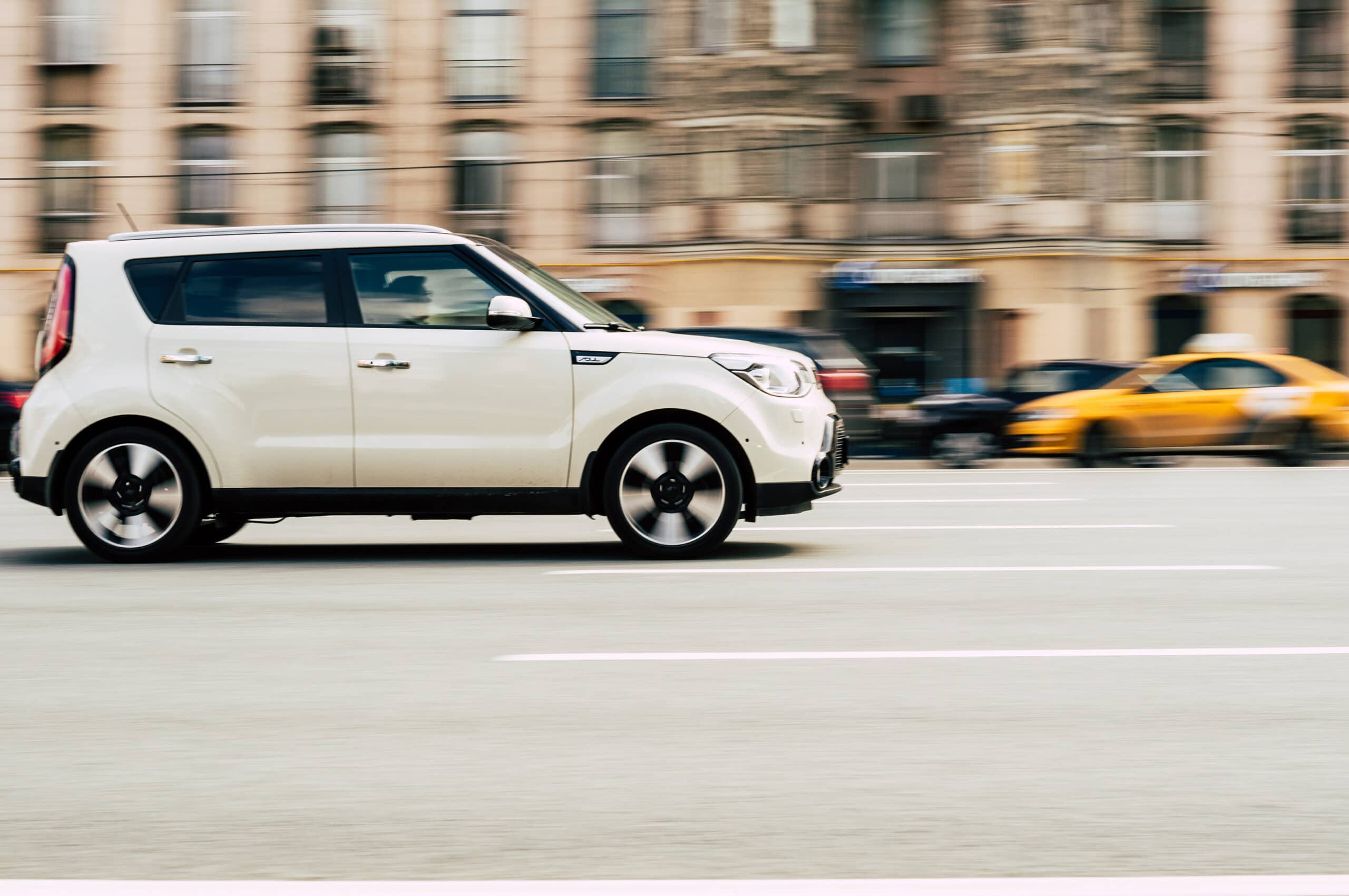 white Kia Soul speeding through a Las Vegas intersection