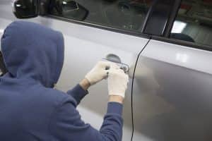 man picking lock to hijack a car in Henderson, Nevada