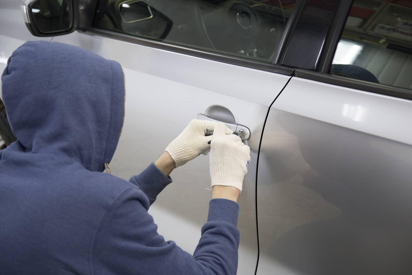 man picking lock to hijack a car in Henderson, Nevada