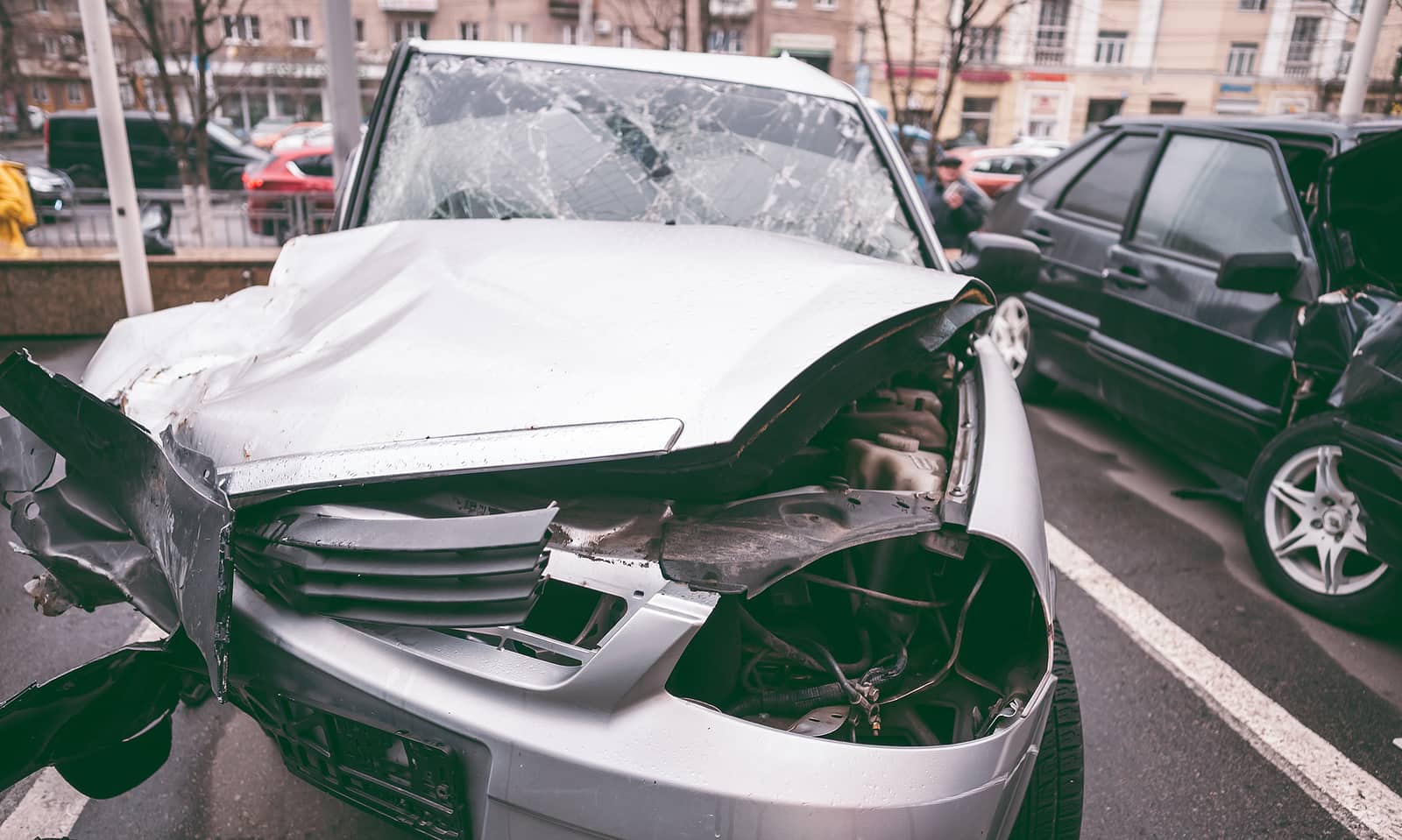 front of car after crashing into highway barrier