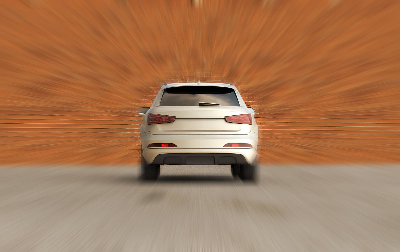 car crashing into a brick wall