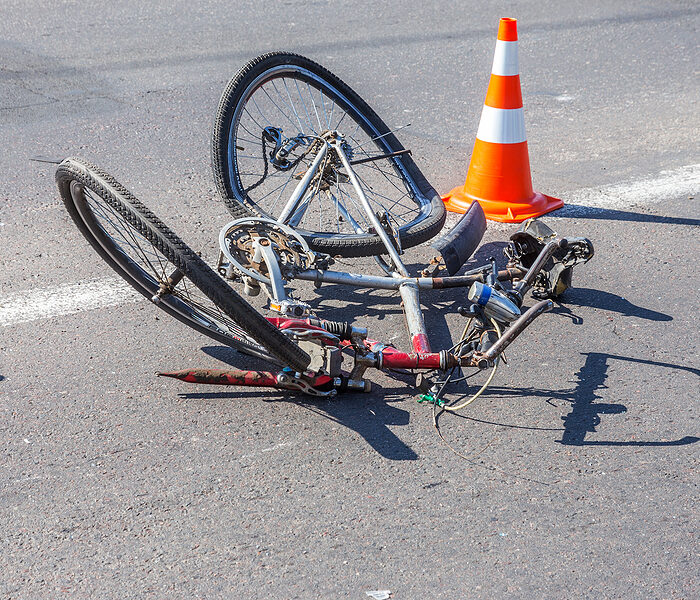 Damaged bike laying in the road after an accident