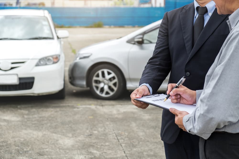 An insurance company representative is processing an insurance claim for the car owner in Las Vegas