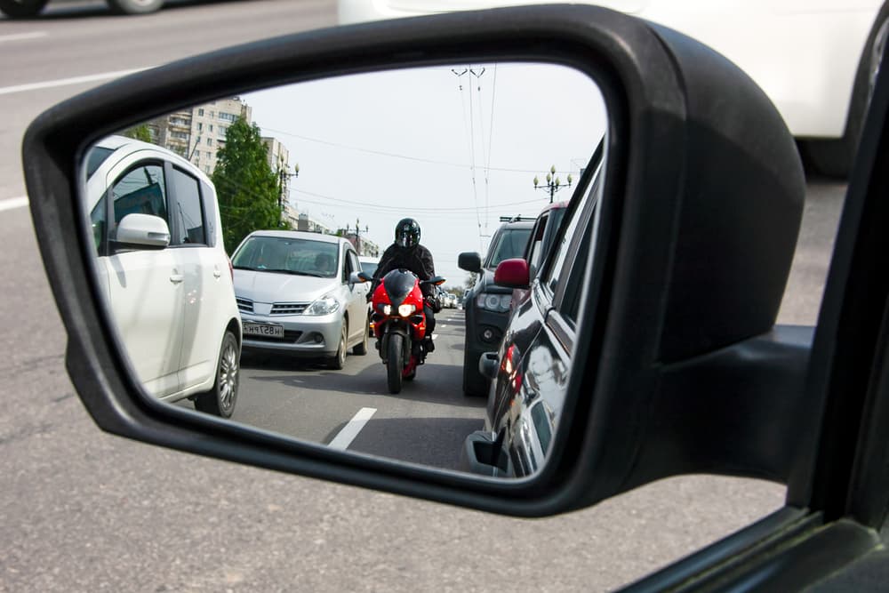 Motorcyclist not keeping a safe distance with cars